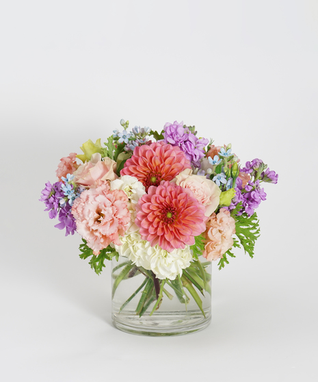 floral arrangement of pinks, lavenders and peaches including roses, hydrangea and dahlias