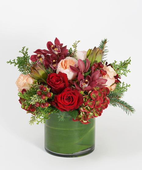 deep red roses, antique hydrangea and burgundy orchids accented with wintergreens