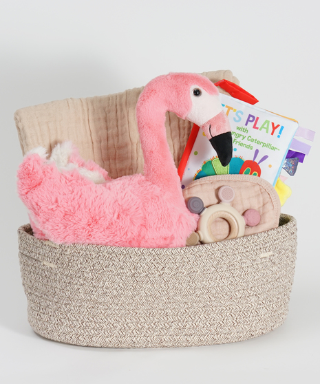 new baby basket with stuffed animal flamingo, blanket, and soft book