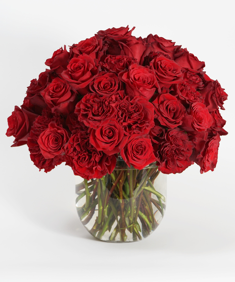 luxury floral design of red roses in a large glass bowl.