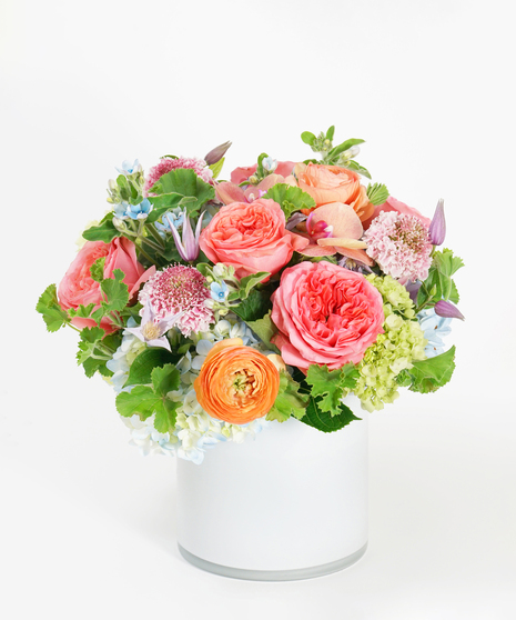 floral arrangement of pinks, lavenders and peaches including roses, hydrangea and scabiosa