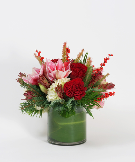 amaryllis, red roses and winter greens flower arrangement
