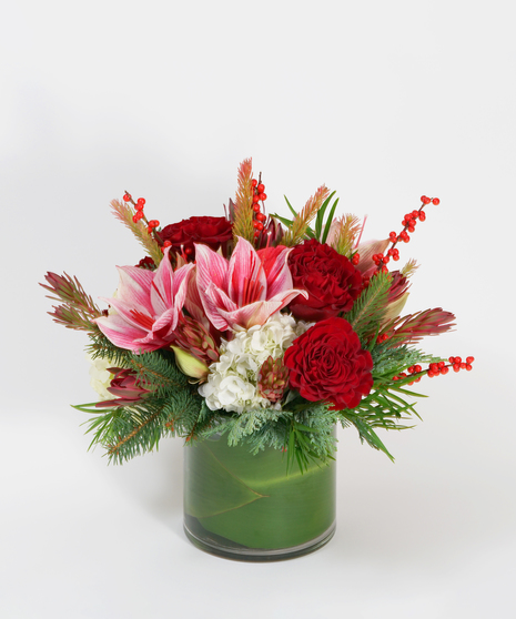 amaryllis, red roses and winter greens flower arrangement