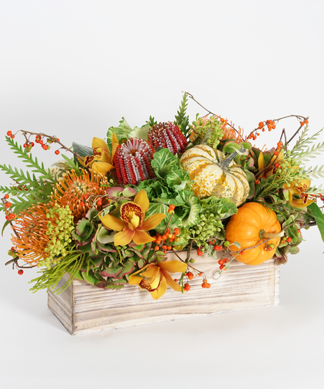 textural autumn arrangement Thanksgiving Centerpiece with orchids, kale, pumpkins and bittersweet