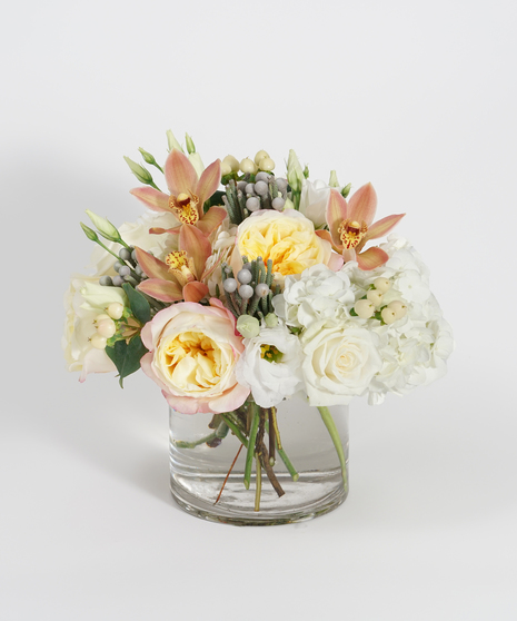 white and cream flower arrangement with unique textural accents and bronze orchids