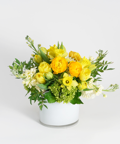 yellow tulips, daffodil, and white hydrangea flower arrangement